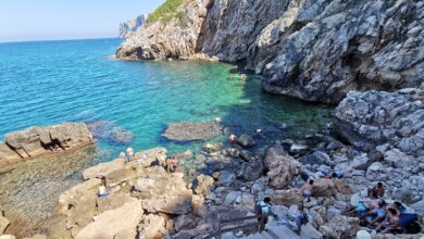 View of the cala with rocks leading into the sea.