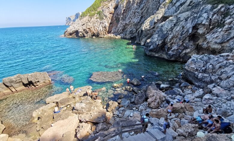 View of the cala with rocks leading into the sea.